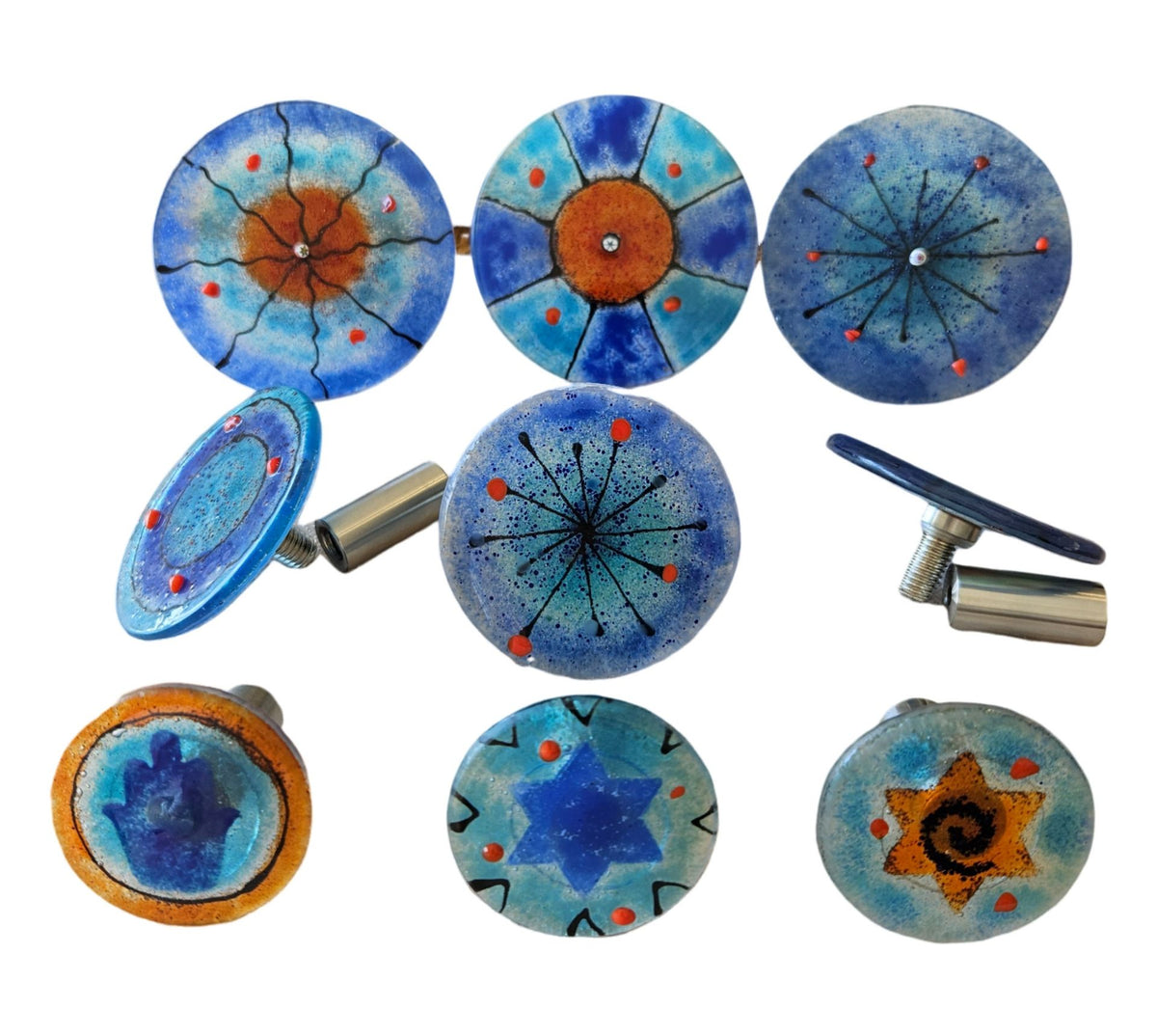 Glass wall art discs shown with metal standoff mounts on the back, blue and orange designs