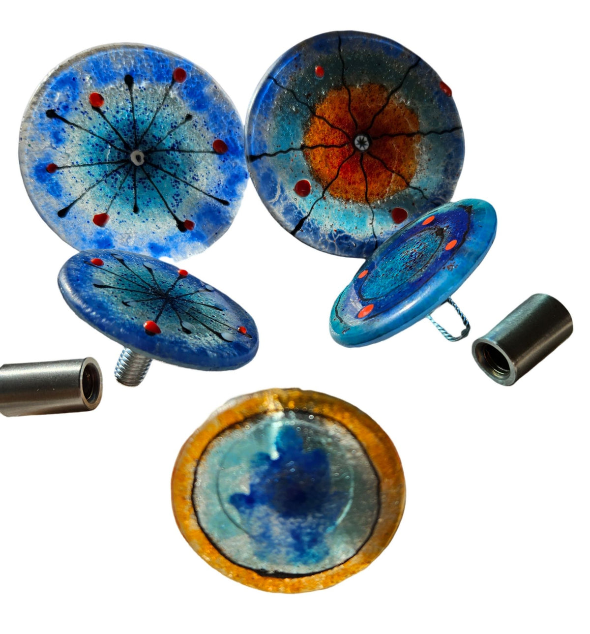 Blue and orange glass wall discs shown with metal standoff mounting hardware