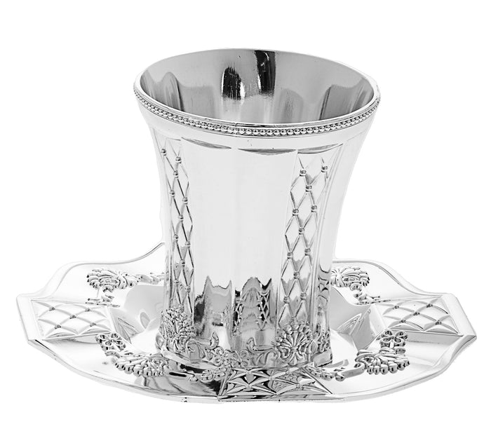 Silver plated Kiddush cup with lattice pattern and beaded rim resting on a decorated tray