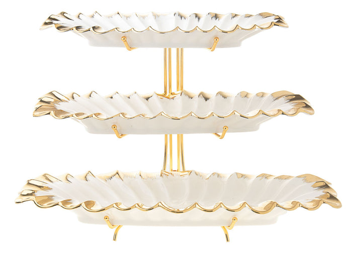 Three-tier white porcelain serving tray with ruffled gold-edged rims on a gold-tone stand