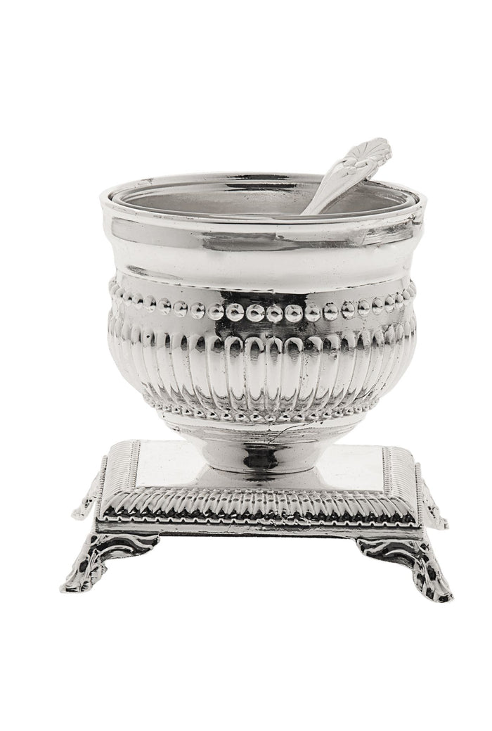 Silver plated fluted salt bowl with beaded rim and small spoon on a footed square base