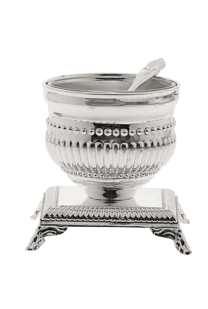 Silver plated fluted salt bowl with beaded rim and small spoon on a footed square base