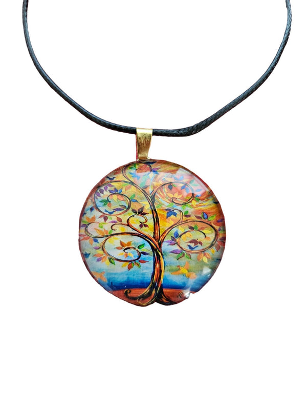 Round glass Springtime Tree of Life pendant with swirling multicolor branches and gold-tone bale on cord