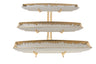 Three graduated white porcelain trays with gold rims stacked on a central post