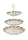 Three tier white porcelain stand with gold rimmed plates graduating in size