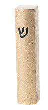 Gold mezuzah case with curling scrollwork winding down its narrow front face