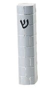 Silver toned mezuzah case with a raised brick pattern running down its narrow face