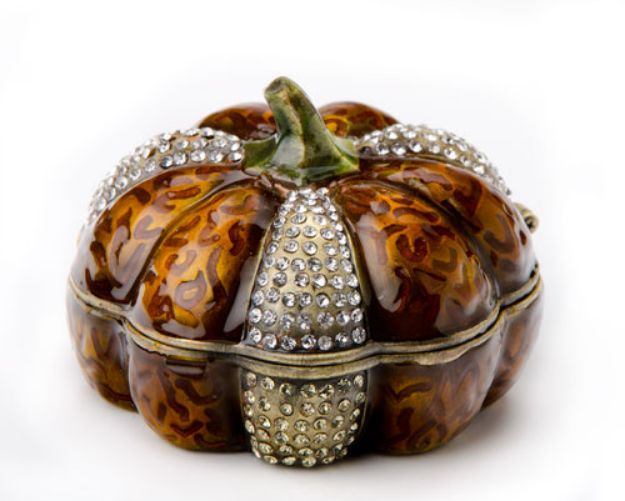 Pumpkin-shaped jeweled spice box in amber-brown with rows of clear stones and a green stem