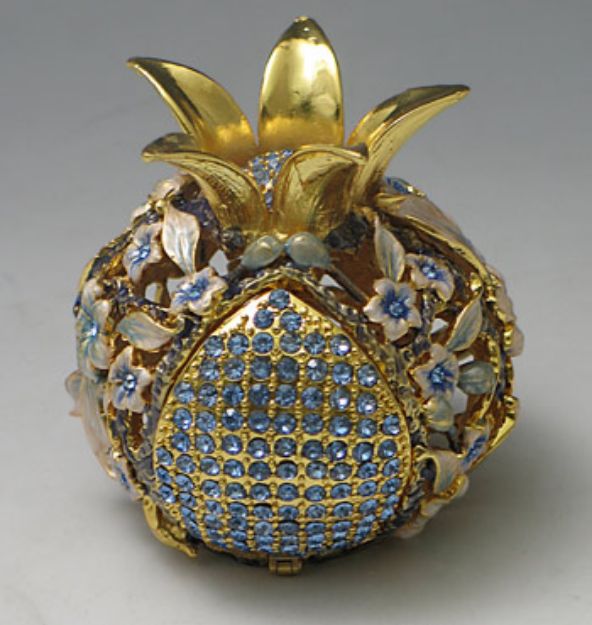 Gold-tone pomegranate spice box set with pale blue stones and small white and blue flowers