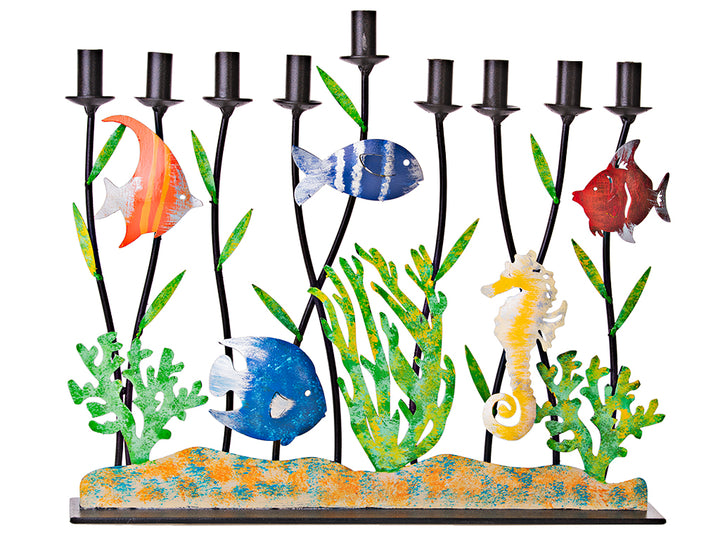 Metal menorah with tropical fish, a yellow seahorse and green coral beneath black candle cups