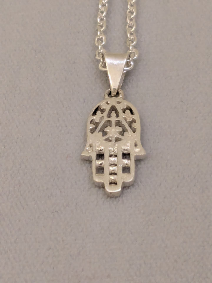 Small cut-out sterling silver hamsa with beaded fingers on a silver link chain