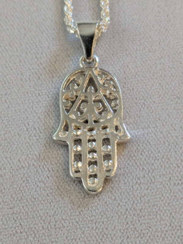 Sterling silver openwork Hamsa with beaded fingers on a rope chain, gray background