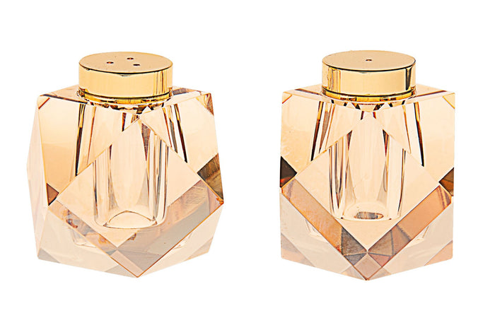 Two faceted gold-tinted crystal salt and pepper shakers with gold-tone caps