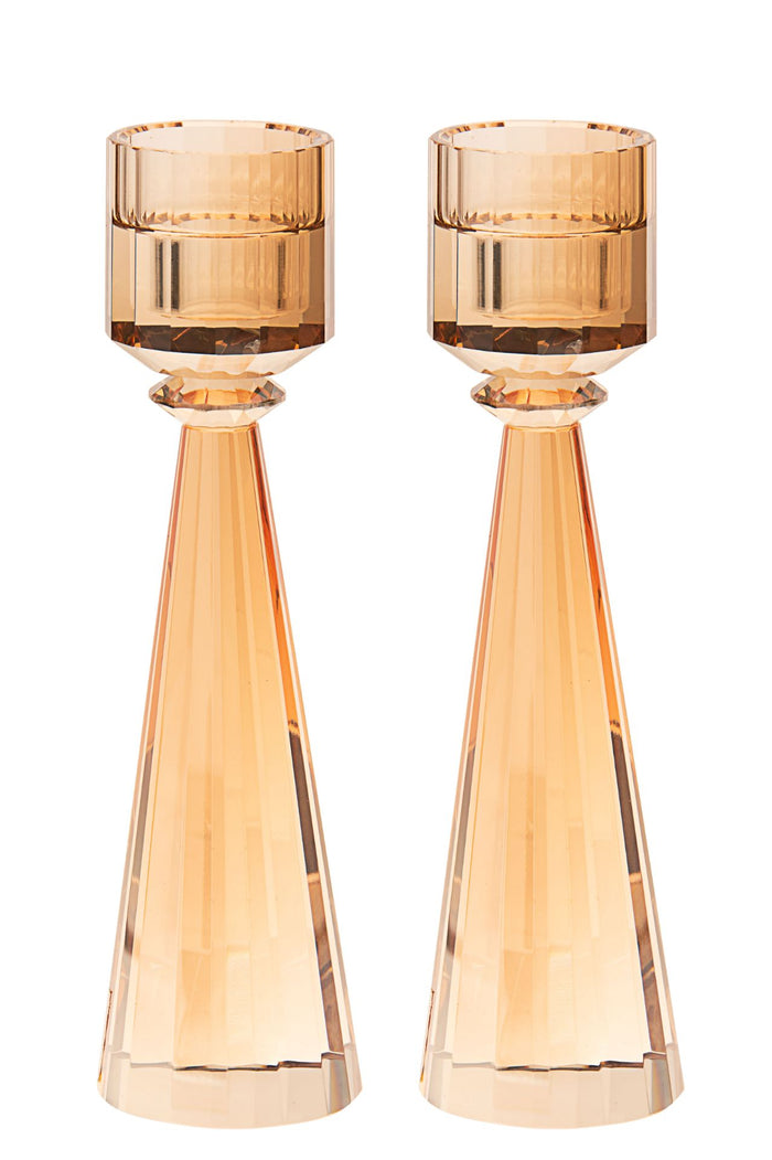 Tall gold toned crystal candlestick with a cut column above a compact square base