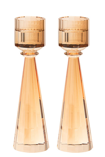 Two gold-tinted crystal candlesticks with faceted cone stems and ribbed cups
