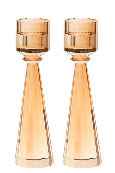 Two gold-tinted crystal candlesticks with faceted cone stems and ribbed cups