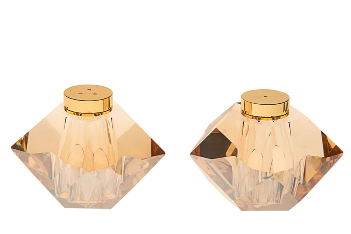 Two amber-gold faceted crystal salt and pepper shakers with gold-tone caps