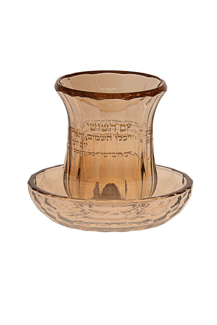 Small gold-trimmed crystal kiddush cup standing on its own round matching tray