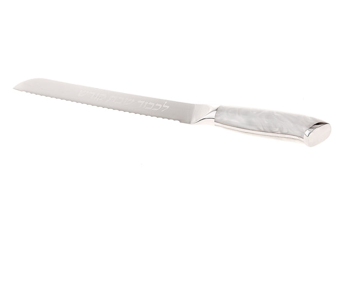 Serrated challah knife with white marbled resin handle and Hebrew lettering etched on the blade