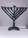 Grey metal Chanukah menorah folded into a V with nine candle holders in a rising line