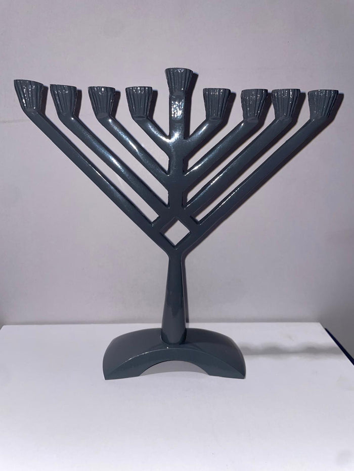 Grey metal V-shape Chanukah menorah with angled arms, raised shamash and arched base