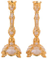 Gold enamel candlestick on a footed square base with a single candle cup