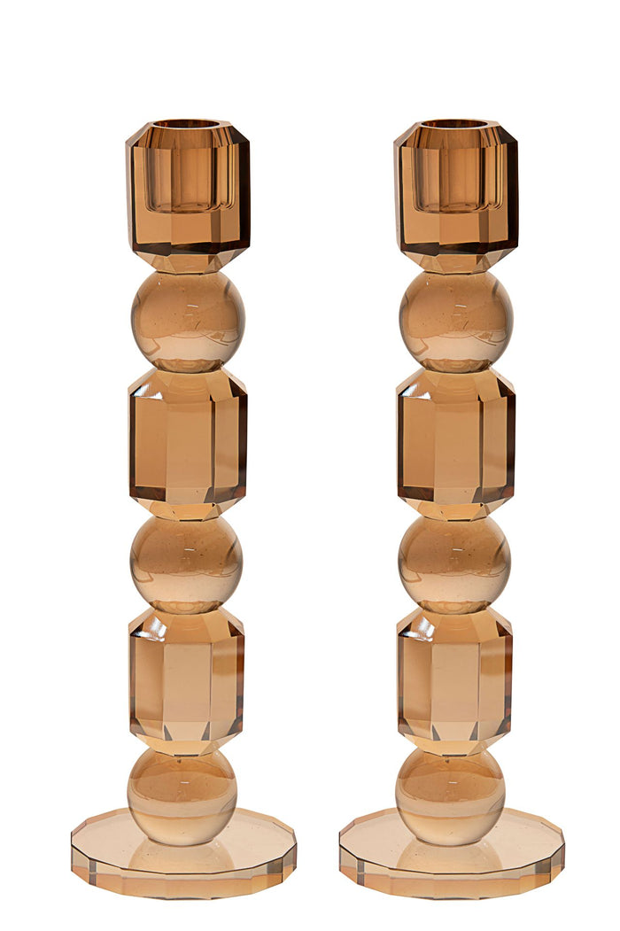 Tall gold toned crystal candlestick column standing on a wide square base