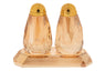 Pair of amber crystal salt and pepper shakers standing on a matching rectangular tray