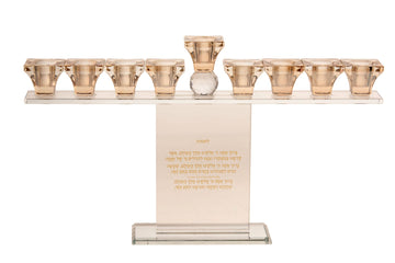 Crystal Chanukah menorah with nine gold tone cups on a straight bar above an upright panel of Hebrew brachos