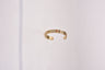 Gold tone open cuff bracelet faced with a row of small enamel mah jongg tiles in red, blue and green