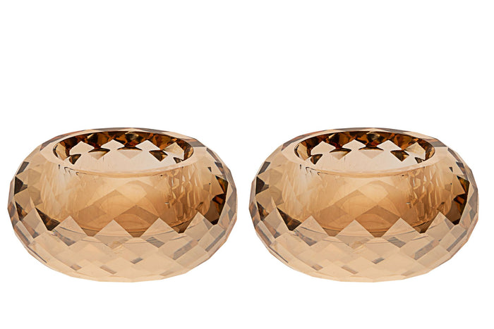 Two faceted amber crystal tea light holders side by side, low rounded shape with cut facets