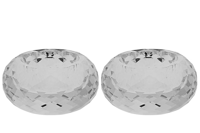 Two faceted clear crystal tea light holders side by side on white, showing the cut-glass facets