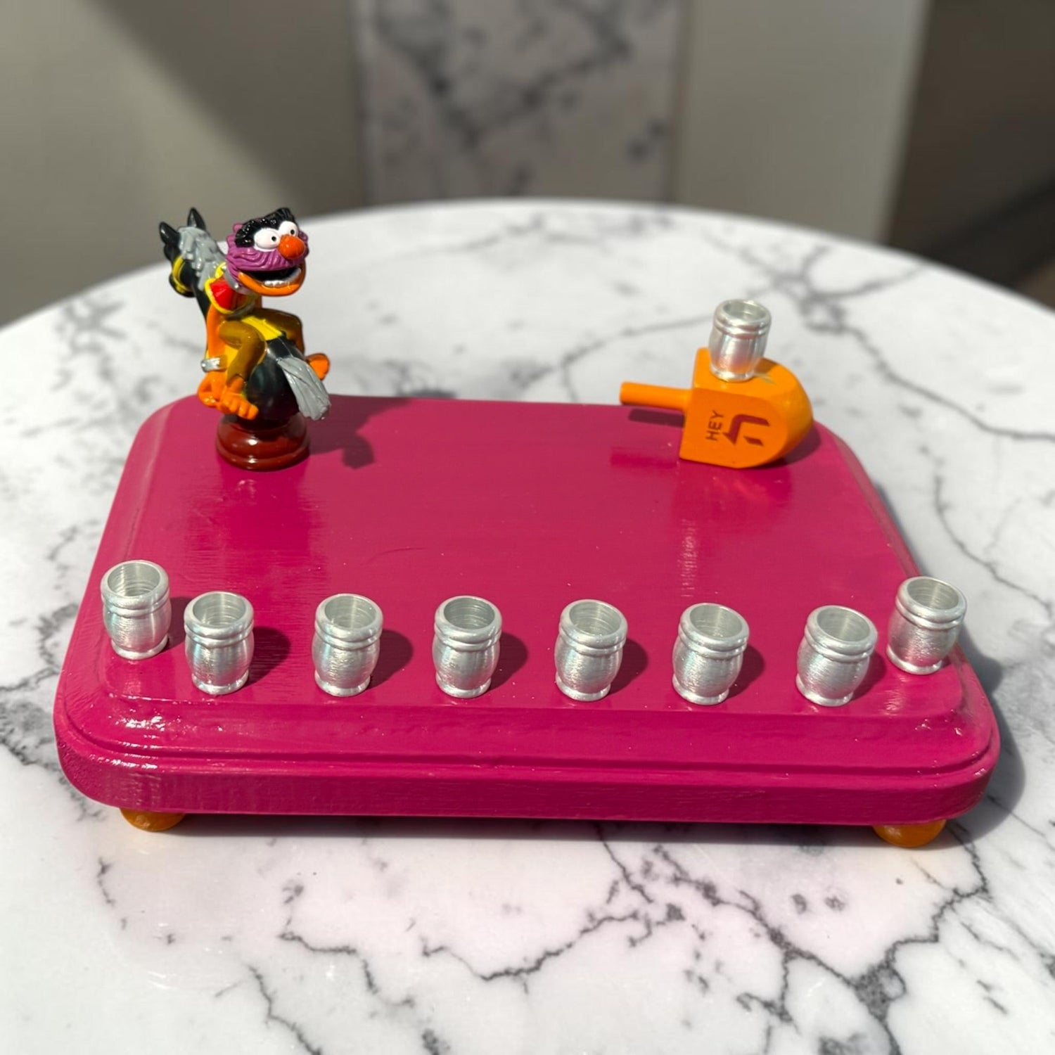 Animal Muppets menorah — wild-haired drummer chess figure above aluminum candle cups | Judaica Square Lakewood (view 6)