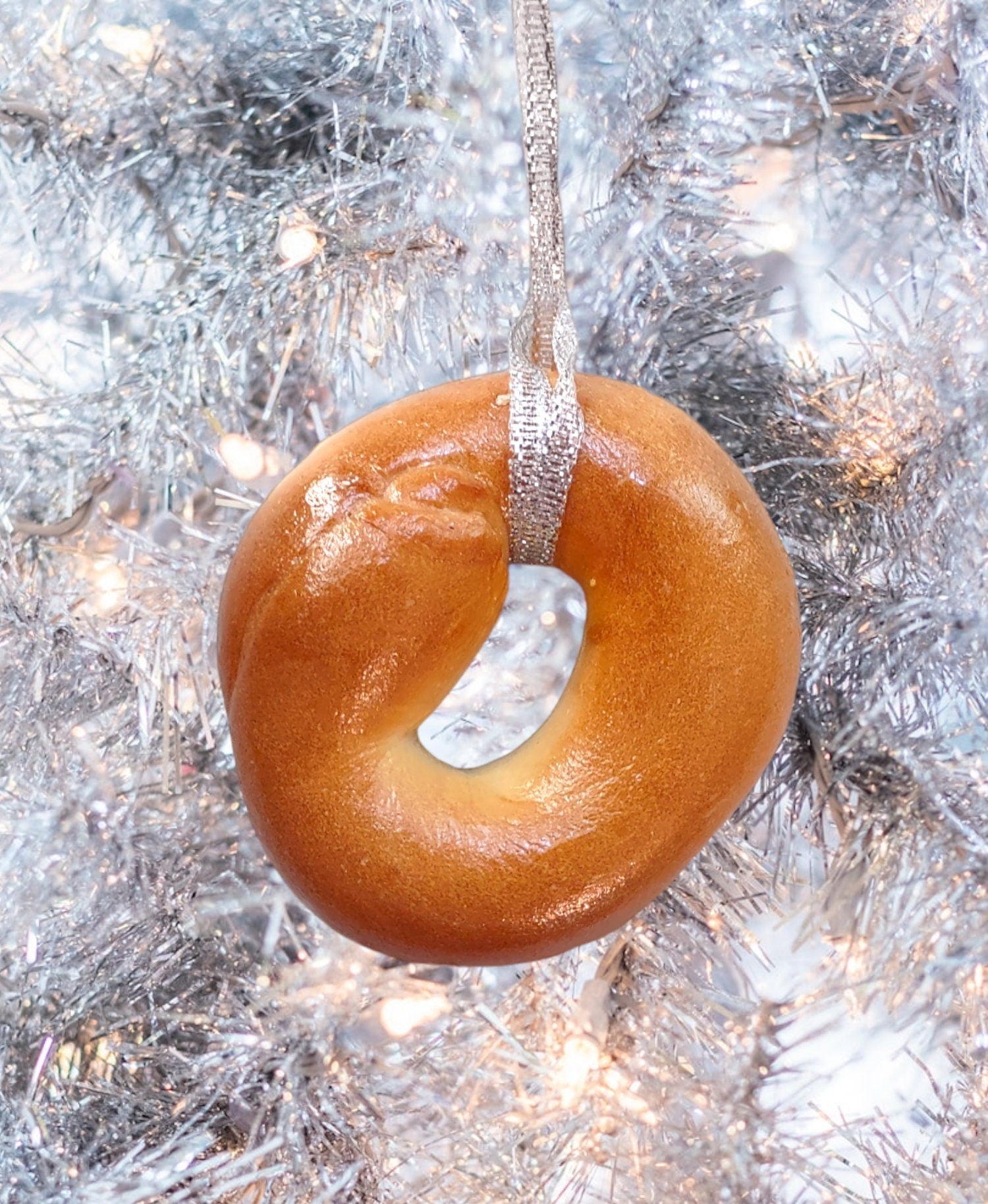 Real preserved everything bagel ornament hanging from a ribbon loop | Judaica Square Lakewood (view 3)