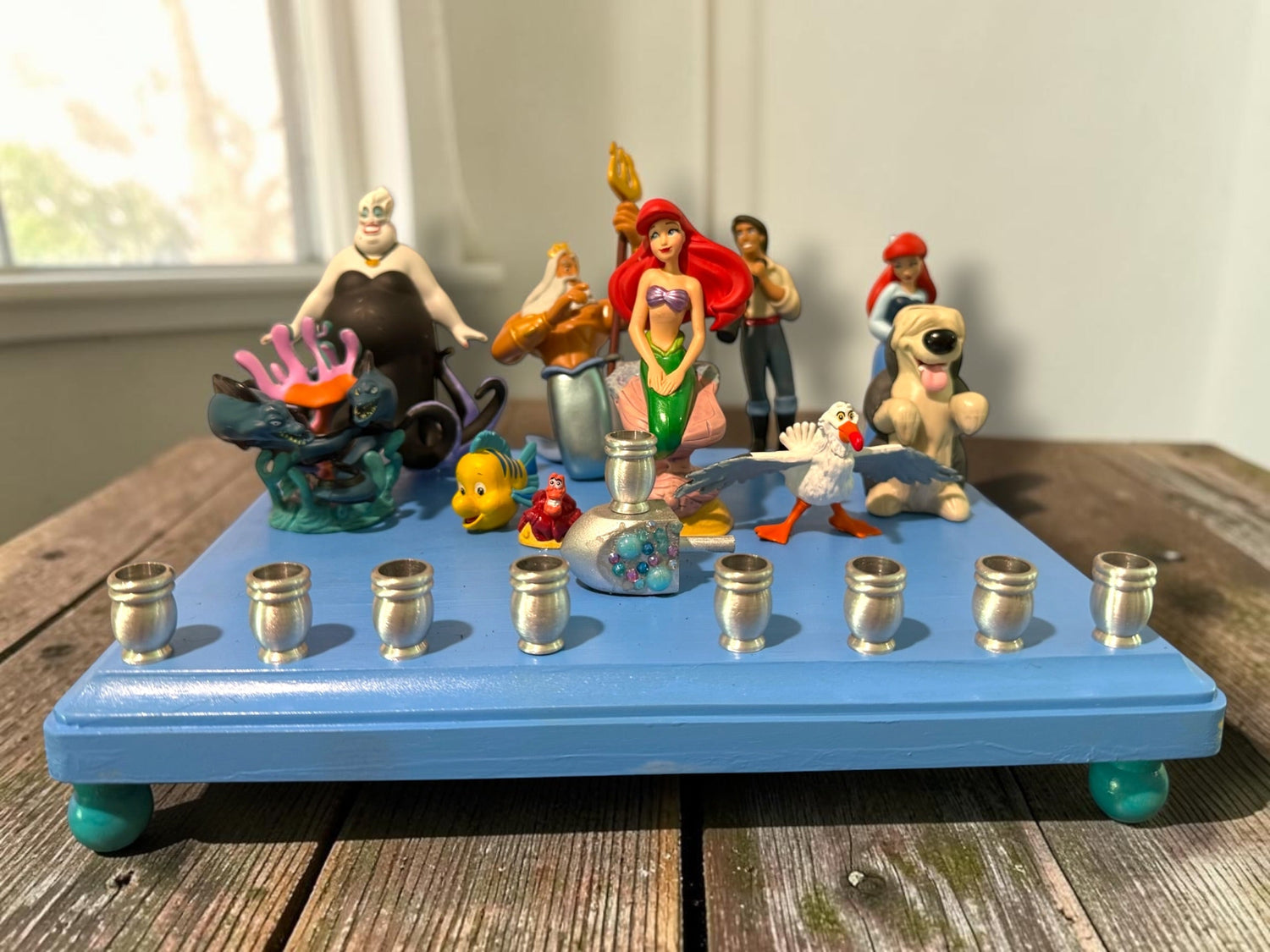 Little Mermaid Menorah — mermaid figures and rhinestones on a painted wood plaque | Judaica Square Lakewood (view 2)