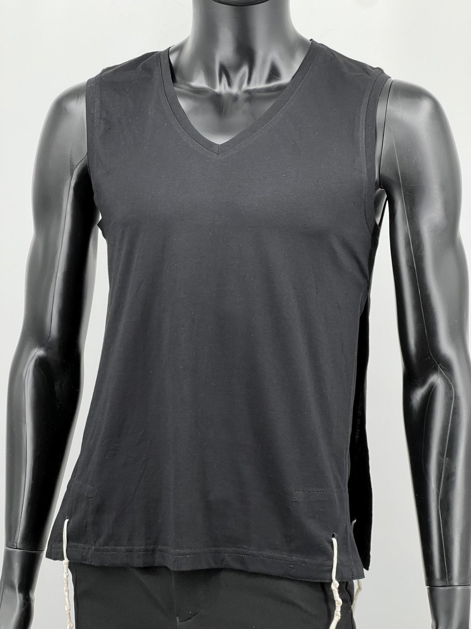 Black sleeveless cotton tzitzit tank top on mannequin, front view
