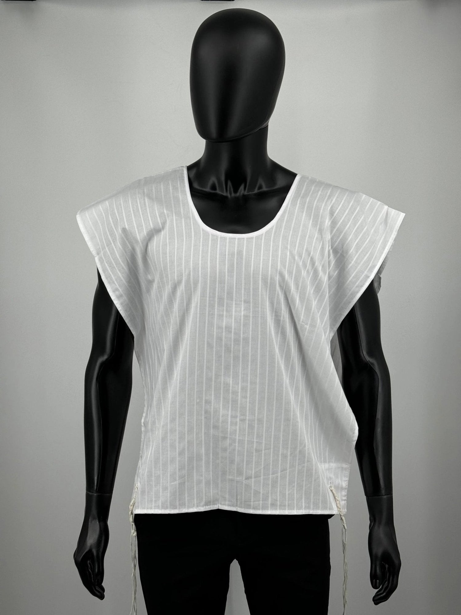 White sleeveless tzitzit shirt on black mannequin
