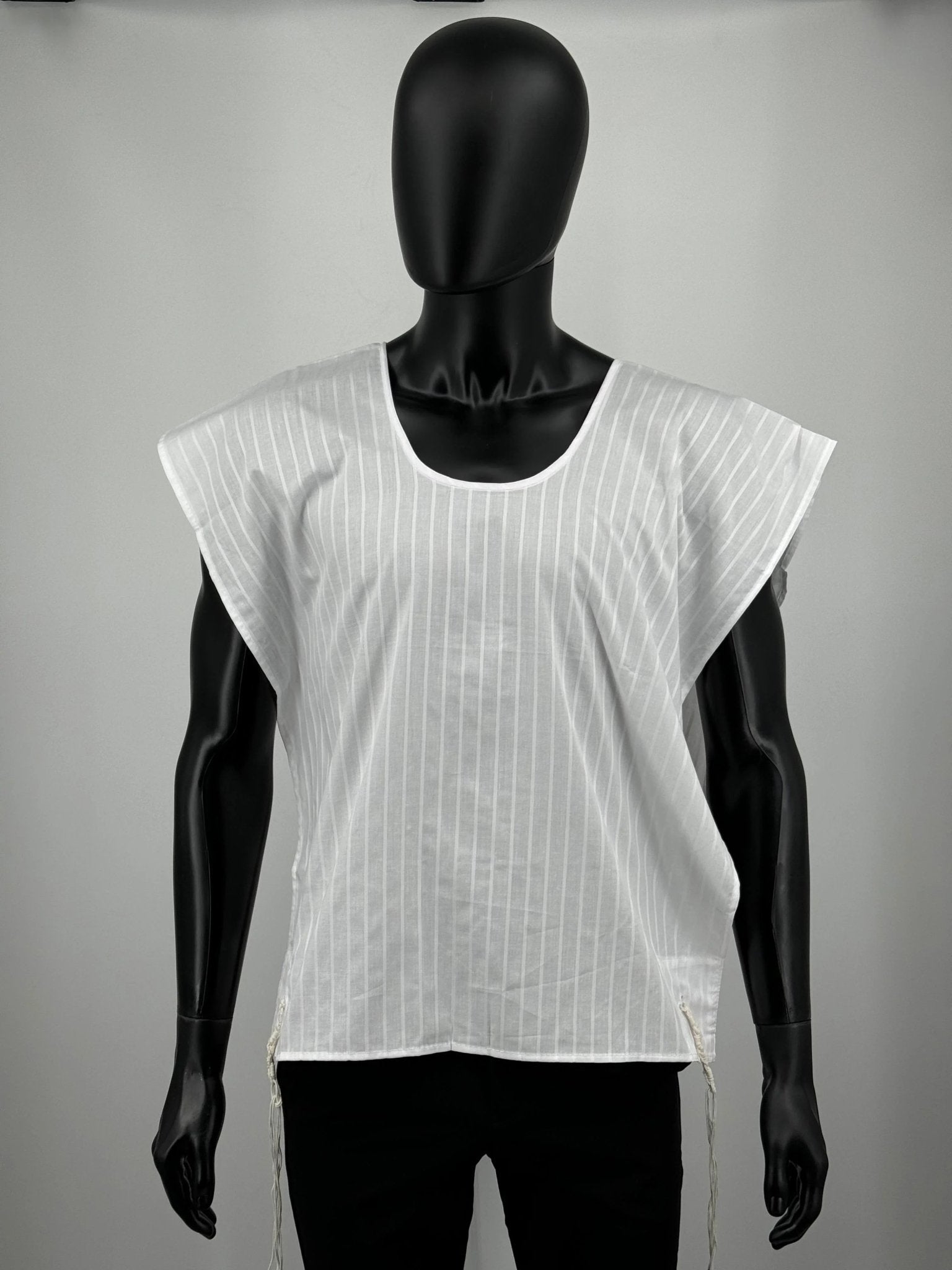 White sleeveless tzitzit shirt on black mannequin