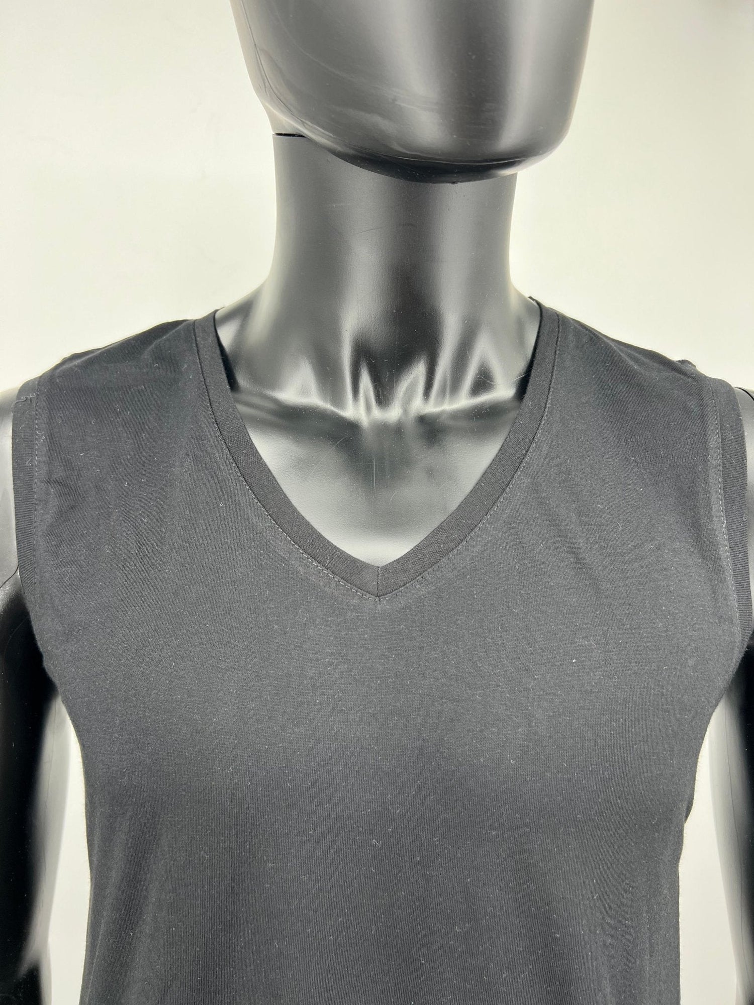 Black sleeveless cotton tzitzit tank top V-neck close-up