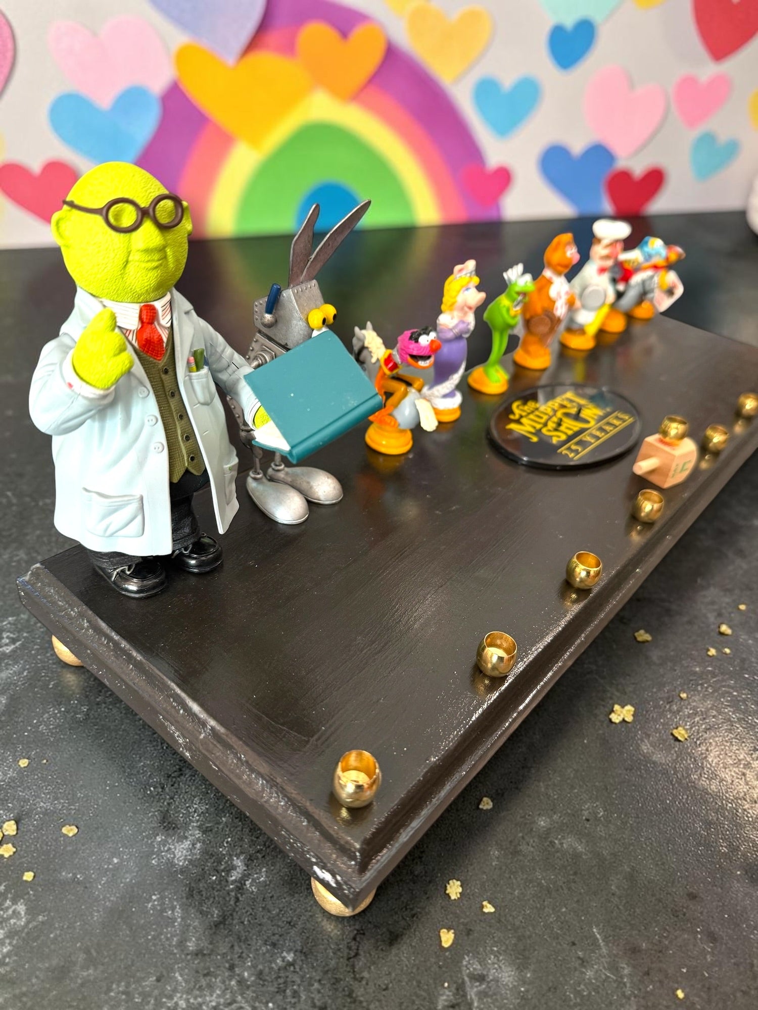 Muppets cast menorah — nine repurposed Muppets figures along a long plaque with brass cups | Judaica Square Lakewoo (view 20)