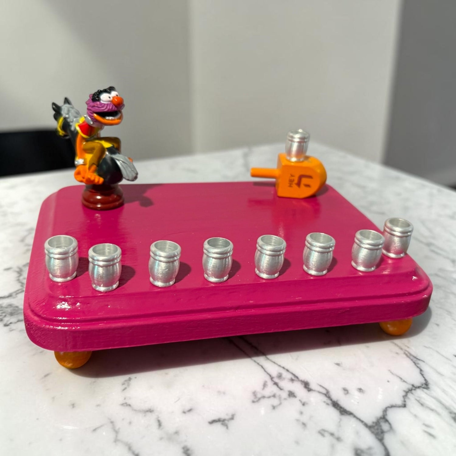 Animal Muppets menorah — wild-haired drummer chess figure above aluminum candle cups | Judaica Square Lakewood (view 5)