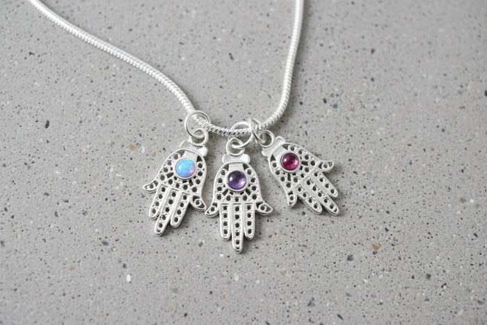 Filigree sterling hamsa pendant set with a purple amethyst stone | Judaica Square Lakewood