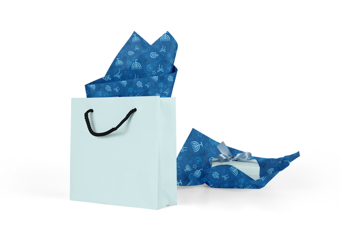 Chanukah Tissue Paper — Chanukah printed tissue paper sheets fanned out beside a gift bag | Judaica Square Lakewood