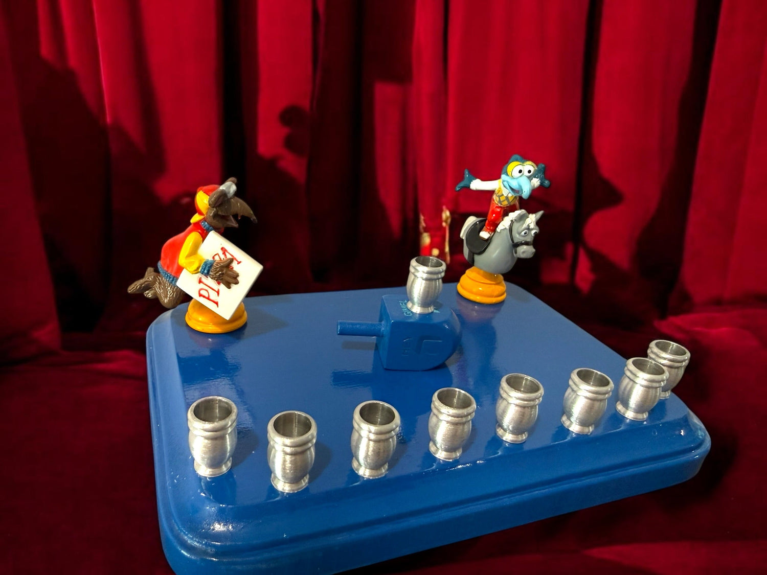 Gonzo and Ralph menorah — two Muppets chess figures sharing a painted wood plaque | Judaica Square Lakewood (view 2)