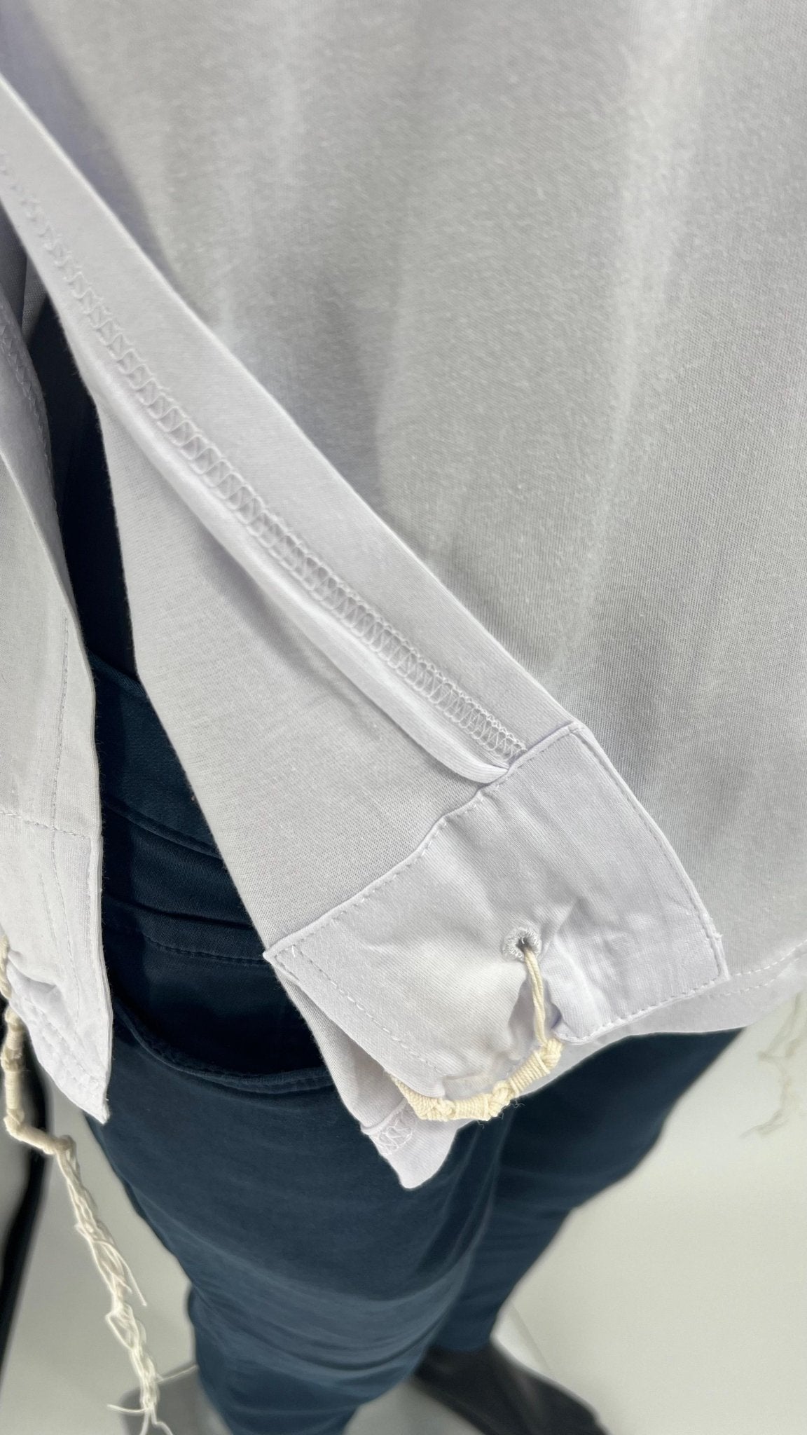 Men's cotton tzitzit t-shirt close-up with tzitzit strings