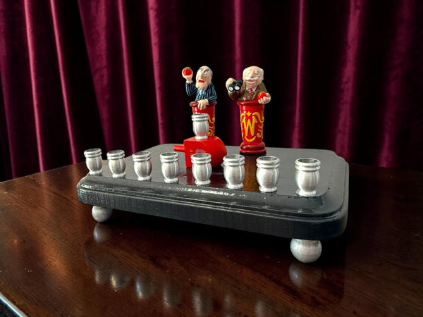 Statler and Waldorf menorah — two old Muppets hecklers over aluminum candle cups | Judaica Square Lakewood