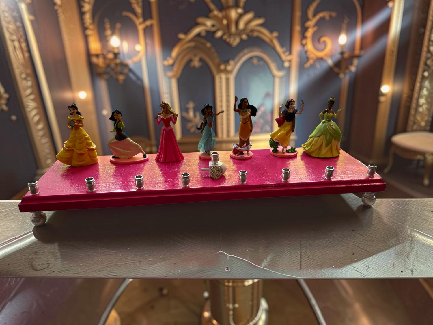 Classic Disney princess menorah — row of repurposed princess figures on pink glitter plaque | Judaica Square Lakewoo (view 2)