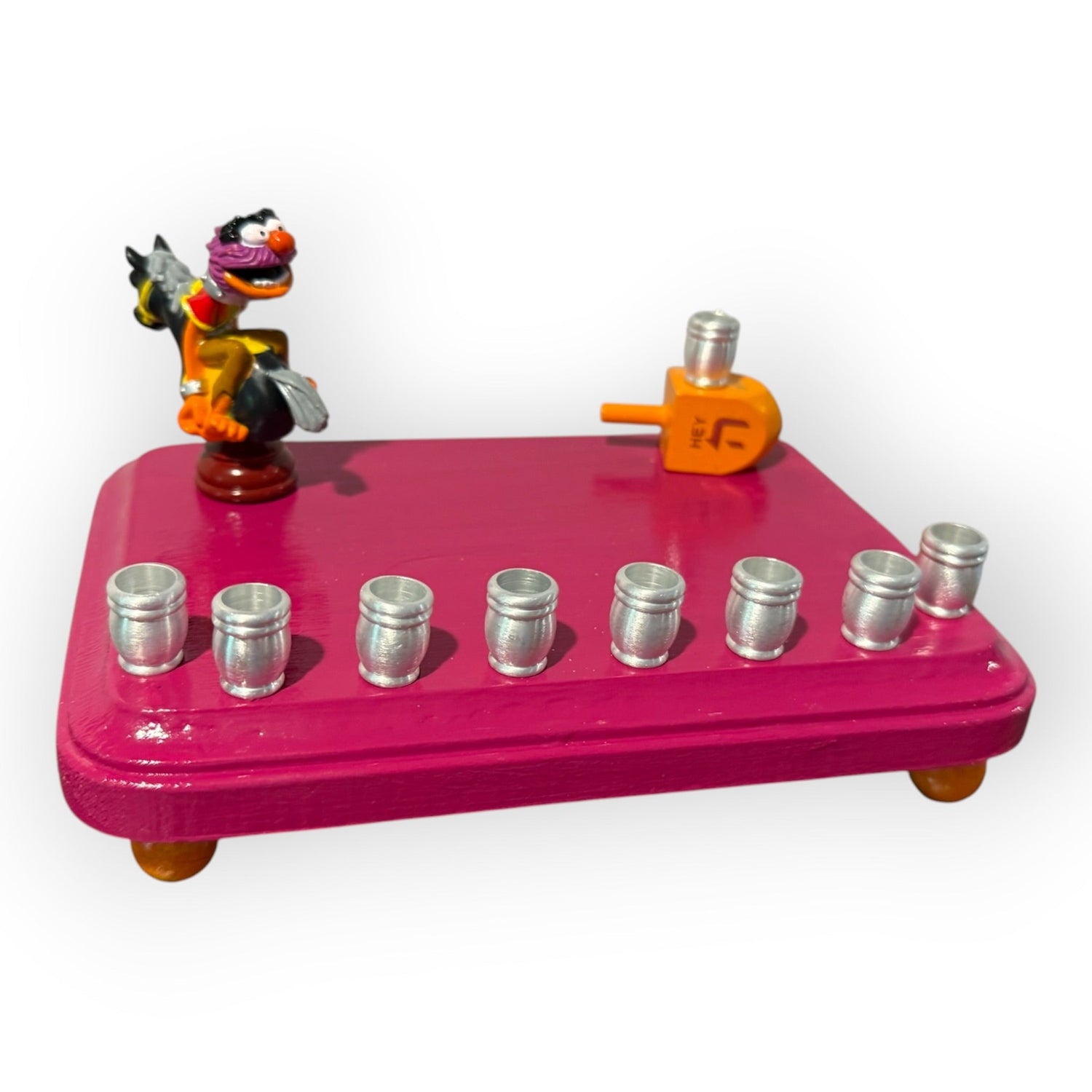 Animal Muppets menorah — wild-haired drummer chess figure above aluminum candle cups | Judaica Square Lakewood (view 2)