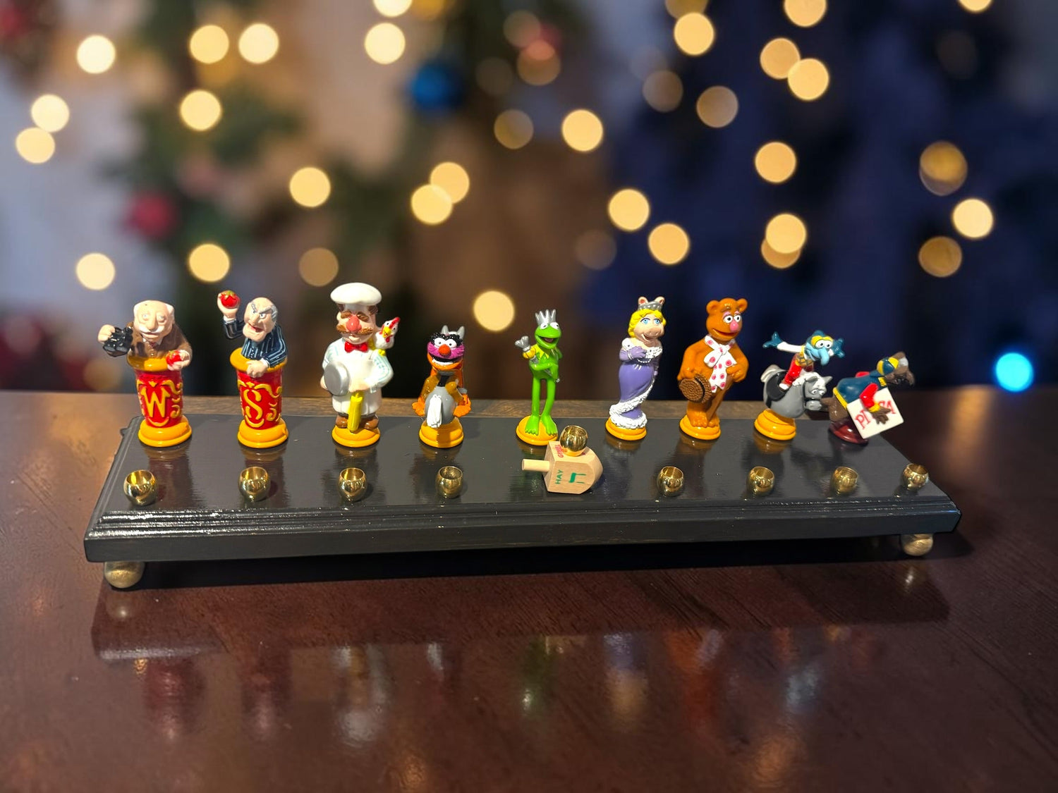 Muppets cast menorah — nine repurposed Muppets figures along a long plaque with brass cups | Judaica Square Lakewood (view 3)