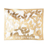 Gold leaf laser-cut challah cover over white with Shabbos V'Yom Tov cut at the bottom